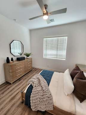 A bedroom with a bed, dresser, and mirror at Zora Encanto, Phoenix, AZ