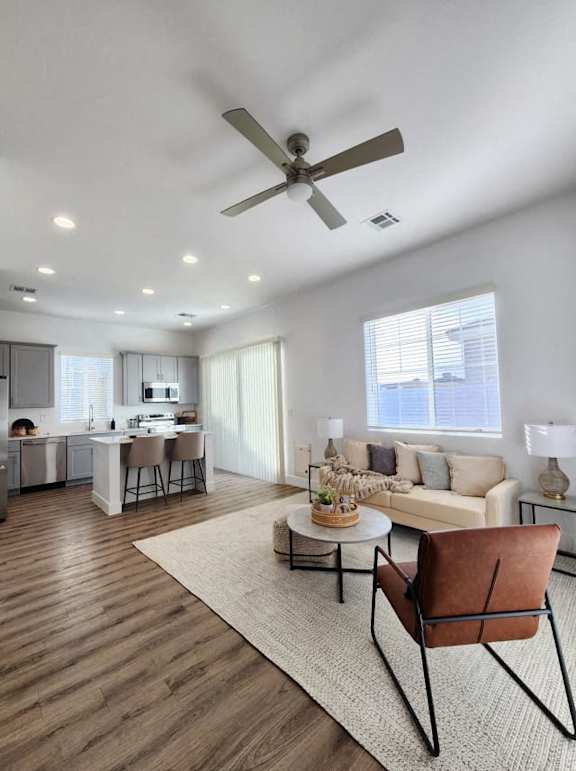 A modern living room with a brown leather chair and a white couch at Zora Encanto, Phoenix, Arizona