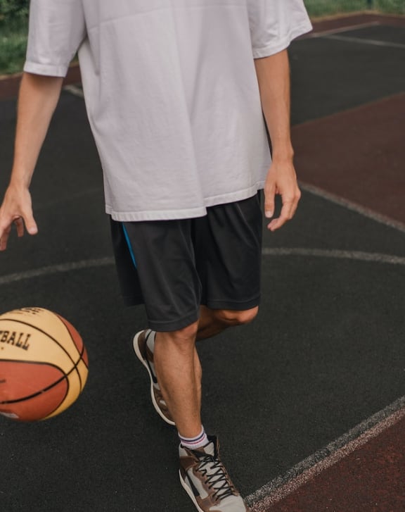 a man is dribbling a basketball on a basketball court