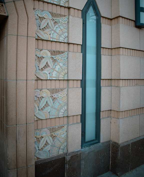 a building on the corner of a street with cars parked in front of it