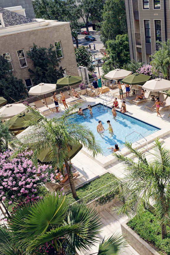 A pool surrounded by palm trees and umbrellas. at Vandeveer, Florida, 32202