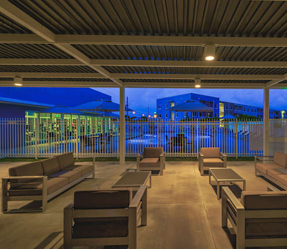 A row of benches are lined up on a patio.