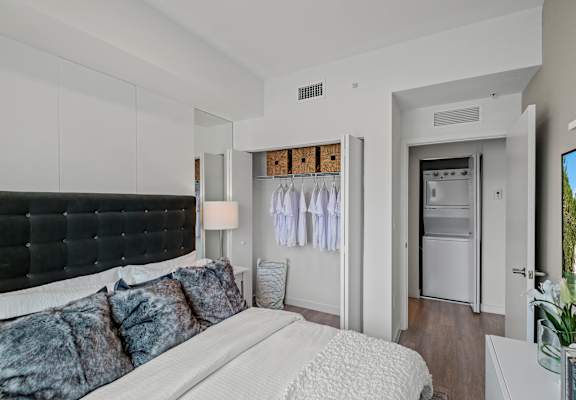 A bedroom with a large bed and a black headboard.