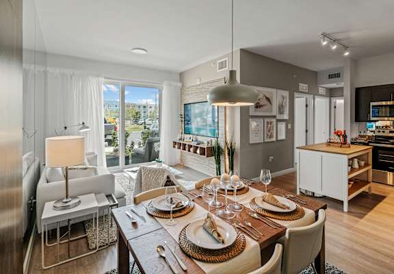 A modern dining room with a table set for a meal.