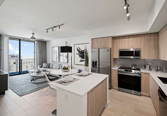a living room filled with furniture and a large window at Regatta at New River, Fort Lauderdale, FL