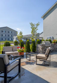 the private patio of our apartments has a table with chairs and an umbrella
