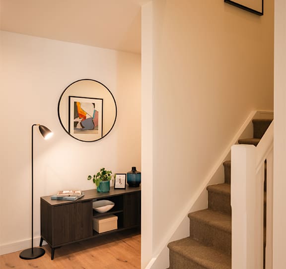 A picture frame hangs on a wall above a wooden cabinet with a lamp on it at Cherrywood Apartments, D18 VY3V, DUBLIN 18