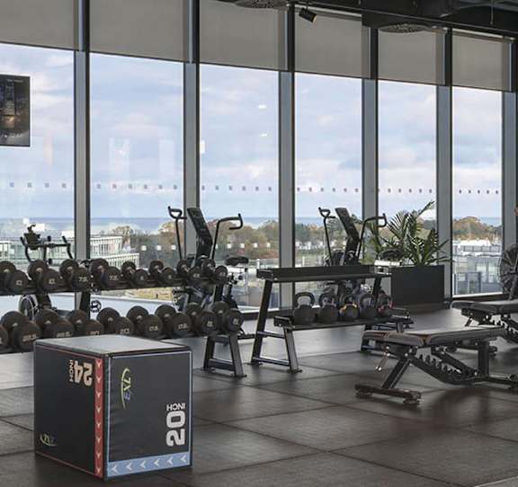 A gym with a view of the ocean.