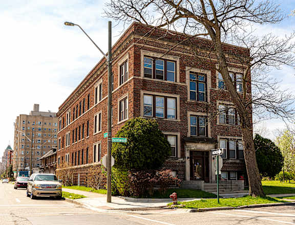 a red brick building on the corner of a city street