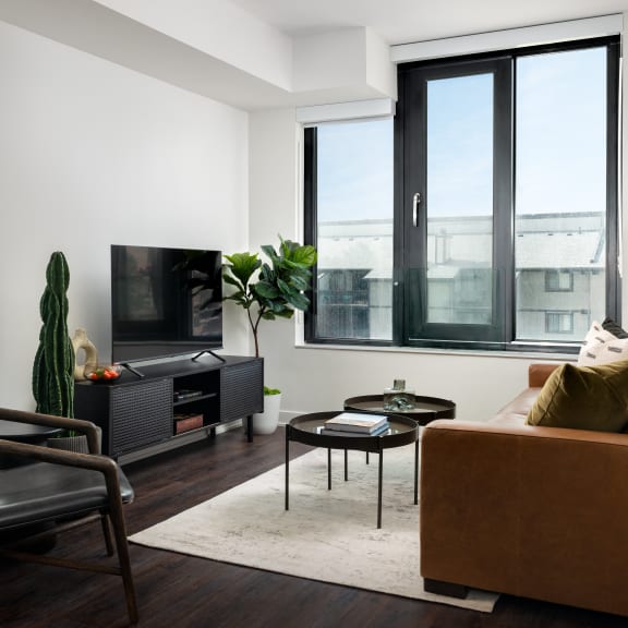 a living room with a couch and a chair and a television