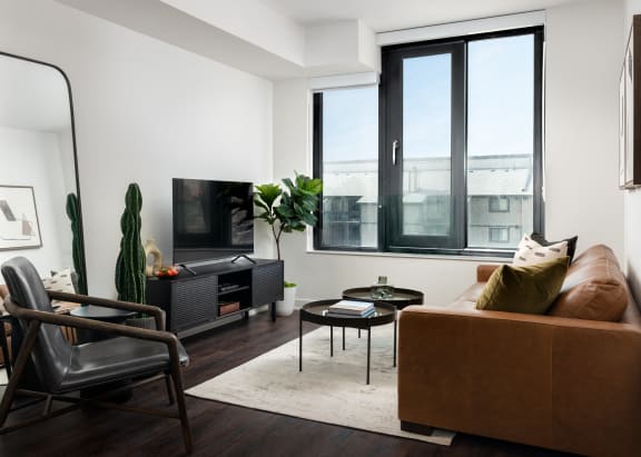 a living room with a couch and a chair and a television
