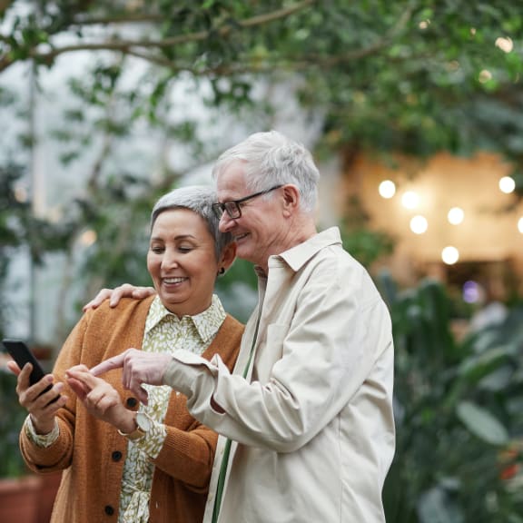 a man and a woman looking at a cell phone