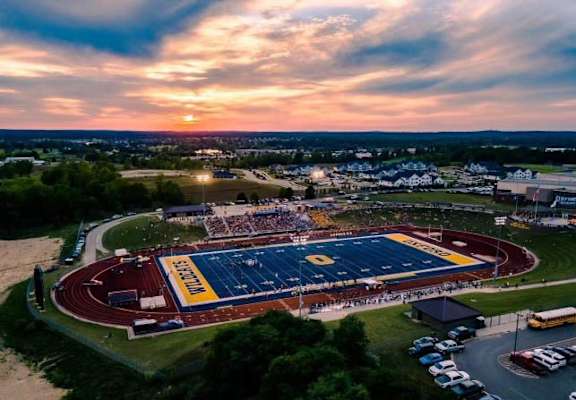 An aerial view of a stadium with a track and field event taking place at Abbey Ridge Apartment Homes, Oxford, MI, Michigan