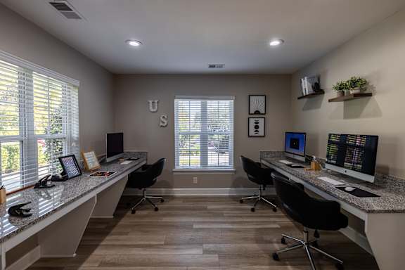 A modern office with two desks and computers.