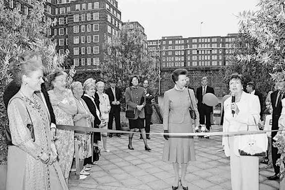 A group of women are standing in front of a building.