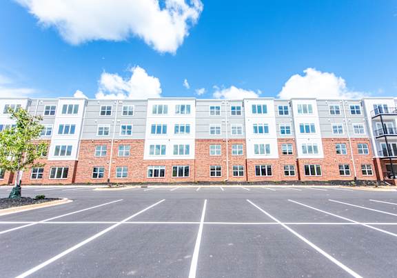 A large building with a parking lot in front of it.