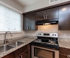 A modern kitchen with a stove and sink.