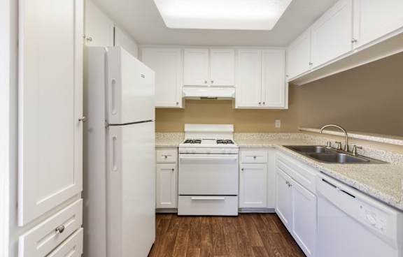 A modern kitchen with a white island and stainless steel appliances.