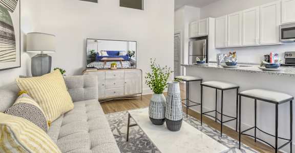 A modern living room with a grey sofa and a grey coffee table.