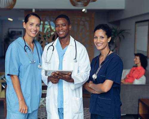 medical professionals standing and smiling Leena Plantation Apartments in Plantation Florida.
