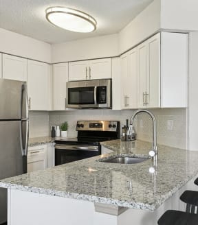 Model Kitchen with White Cabinets at Retreat at Crosstown Apartments in Riverview, FL-SMLAM