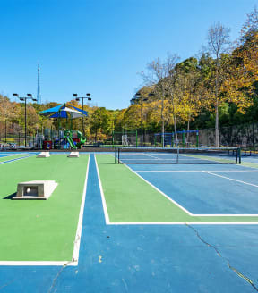 Tennis courts, cornhole and playground at Edgewater at Sandy Springs