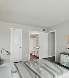 Model Bedroom with Carpet and attached Bathroom at Heron Walk Apartments in Jacksonville, FL-SMLAM.