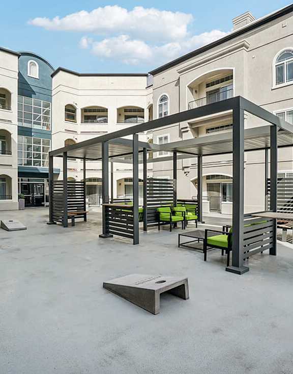Rooftop Patio with Lounge Furniture and Cornhole at Altitude on Fifth Apartments located in Salt Lake City, UT.