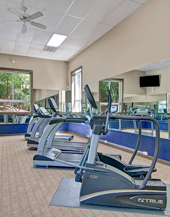 Woman running on a treadmill at the fitness center