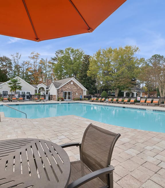 Community Swimming Pool with Pool Furniture at Lake Cameron Apartments located in Apex, NC-SMLAM.
