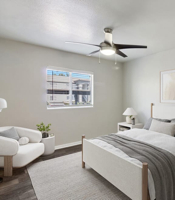 Model Bedroom with Wood-Style Flooring and Window View at Loma Vista Apartments in Las Vegas, NV-SMLAM.
