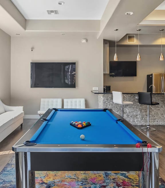Community Clubhouse with Game Tables & Kitchenette Area at Reserve at Rancho Apartments located in Moreno Valley, CA-SMLAM.