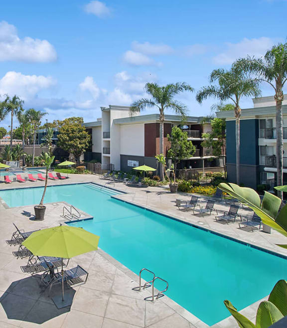 Community Swimming Pool with Pool Furniture at Madison Park Apartments located in Anaheim, CA-SMLAM.