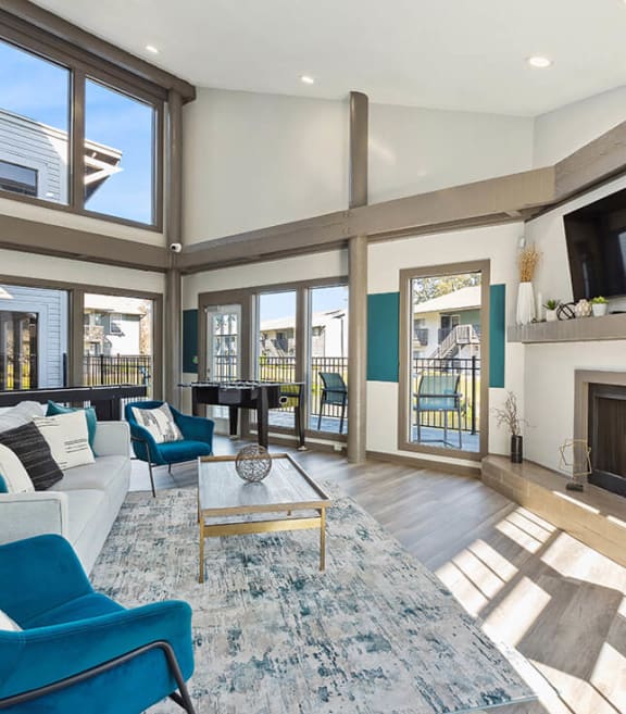  Community Clubhouse with Lounge Furniture and Fireplace at Seven Lakes at Carrollwood Apartments in Tampa, FL.