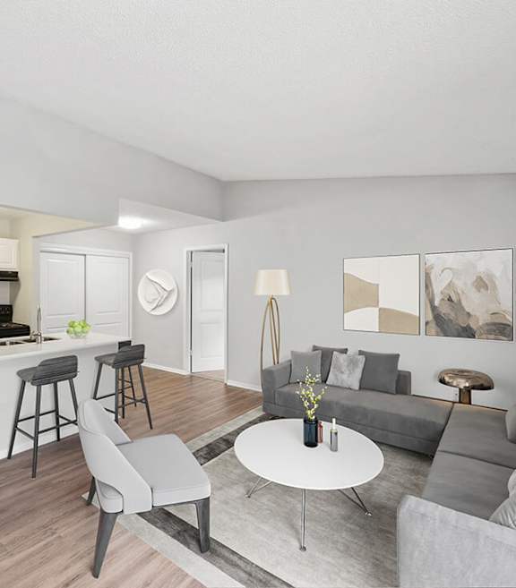 Model Living Room and Kitchen with Wood-Style Flooring at Vue at Baymeadows Apartments located in Jacksonville, FL-SMLAM.