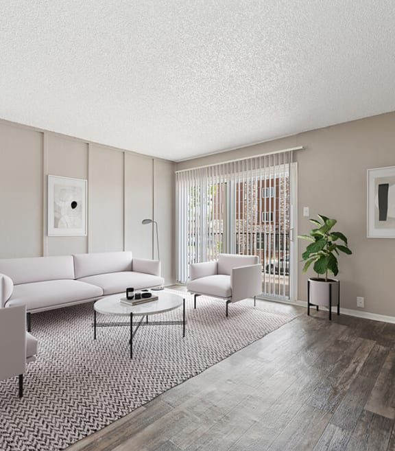 Model Living Room with Wood-Style Flooring and Patio Accessibility at Bridges at 9 Mile Station Apartments in Denver, CO-SMLAM.