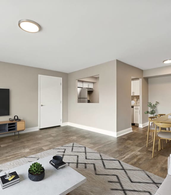 Model Living Room with Wood-Style Flooring and Patio Accessibility at Heights at Marlborough Apartments located in Marlborough, MA-SMLAM.