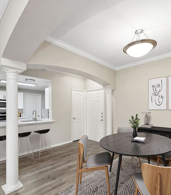 Model Dining Room with Wood-Style Flooring and View of Kitchen at Allure North Dallas Apartments located in Dallas, TX-SMLAM.