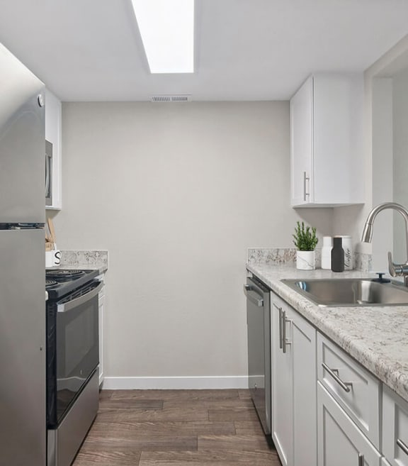 Model Kitchen with White Cabinets and Wood-Style Flooring at Overlook Point Apartments in Salt Lake City, UT-SMLAM.