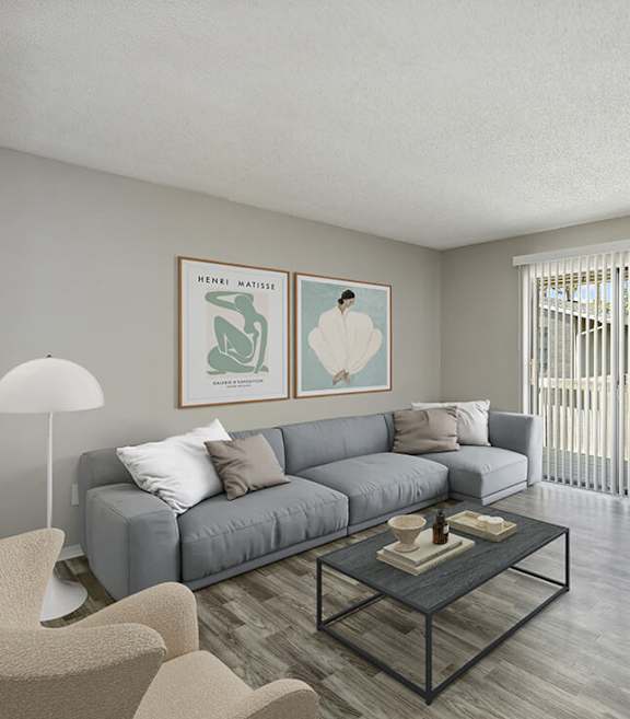 Model Living Room with Wood-Style Flooring and Patio Accessibility at Arbors at Orange Park Apartments located in Orange, Park FL-SMLAM.