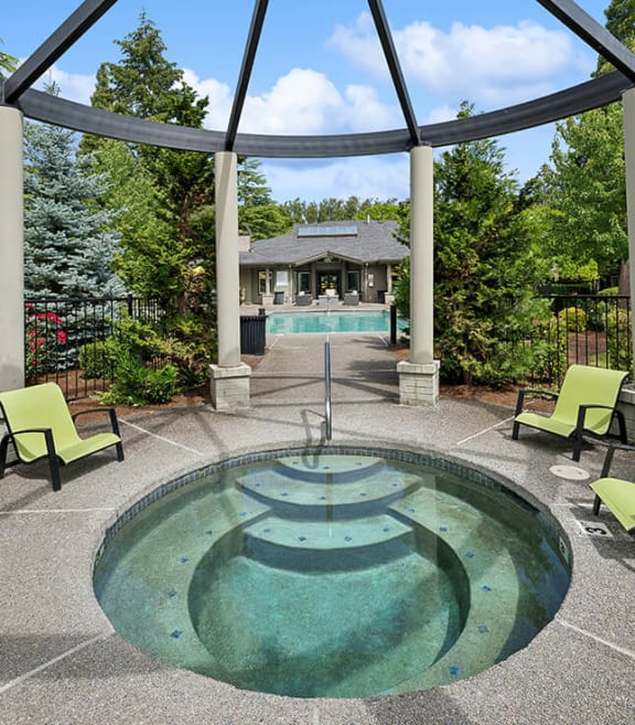 Community Hot Tub and Swimming Pool with Pool Furniture at The Club Apartments located in Hillsboro, OR-SMLAM.