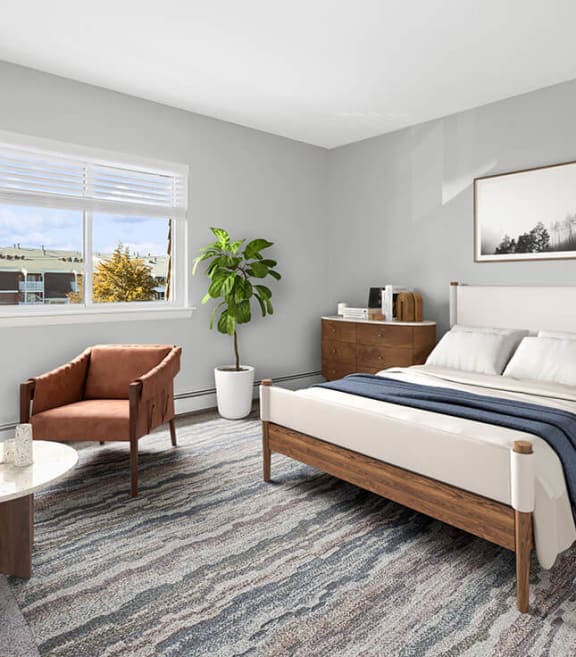 Model Bedroom with Carpet and Window View at Stone Ends Apartments located in Stoughton, MA-SMLAM.