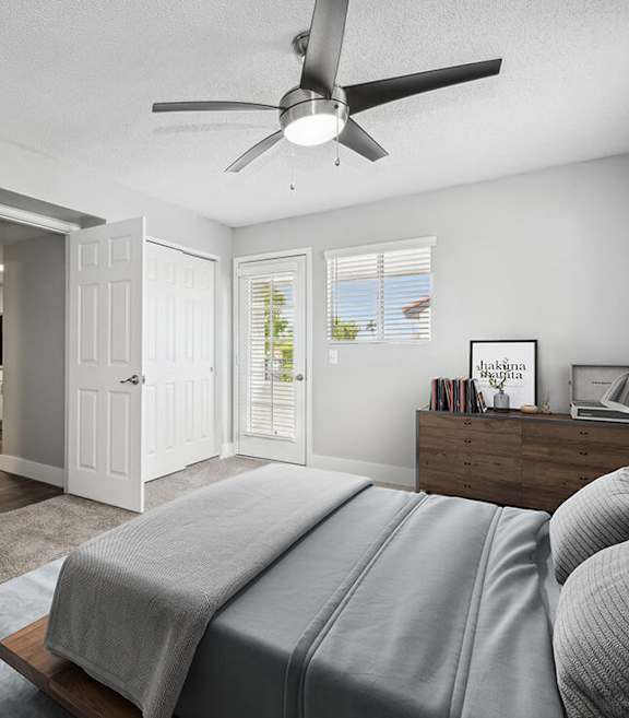Model Bedroom with Carpet and Patio Accessibility at Stillwater Apartments located in Glendale, AZ-SMLAM.
