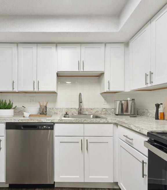 Model Kitchen with White Cabinets and Wood-Style Flooring at Meadows at Marlborough Apartments located in Marlborough, MA-SMLAM.