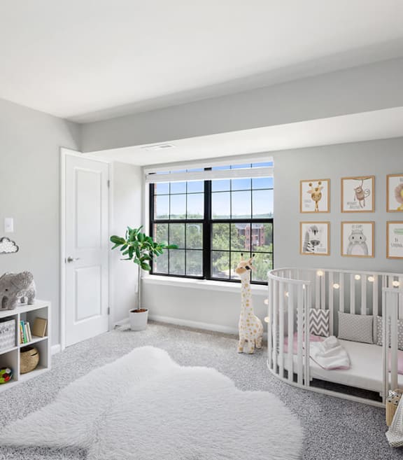 Model Bedroom with Carpet and Window View at Brightwood Forest Apartments in Dale City, VA-SMLAM.