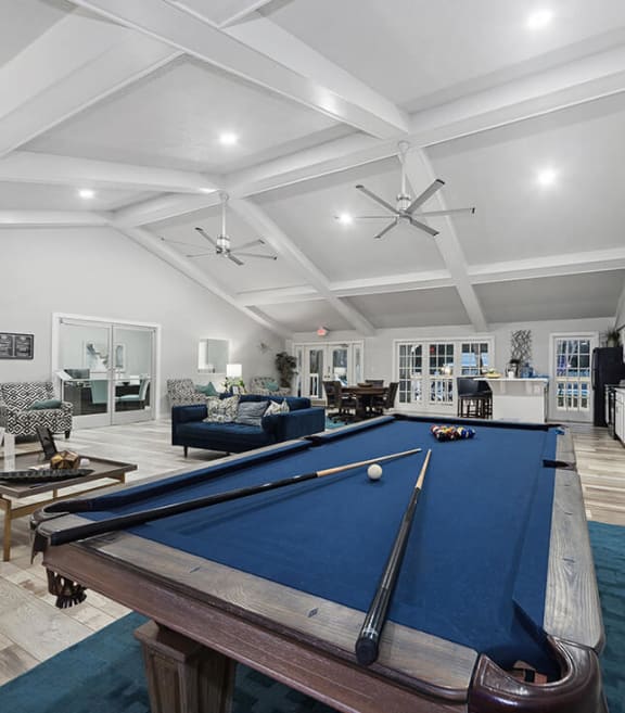 Community Clubhouse with Lounge Furniture and Pool Table Area at Walden Lake Apartments in Plant City, FL-SMLAM.