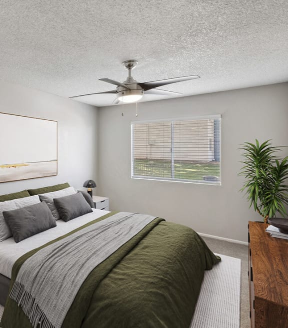 Model Bedroom with Carpet and Window View at Solano Springs Apartments located in Tucson, AZ-SMLAM.