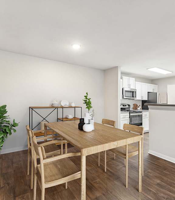 Model Dining Room with Wood-Style Flooring and View of Kitchen at Lake Cameron Apartments located in Apex, NC-SMLAM.