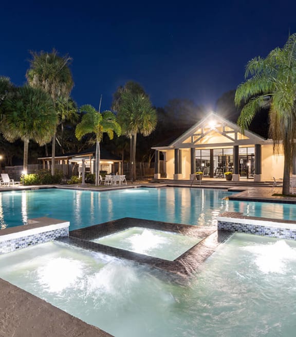 Community Swimming Pool with Pool Furniture at Caribbean Breeze Apartments in Tampa, FL.