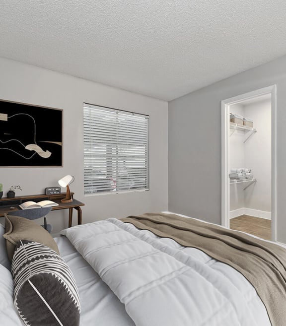Model Bedroom with Carpet and Walk In Closet at Crystal Creek Apartments in Phoenix, AZ-SMLAM.